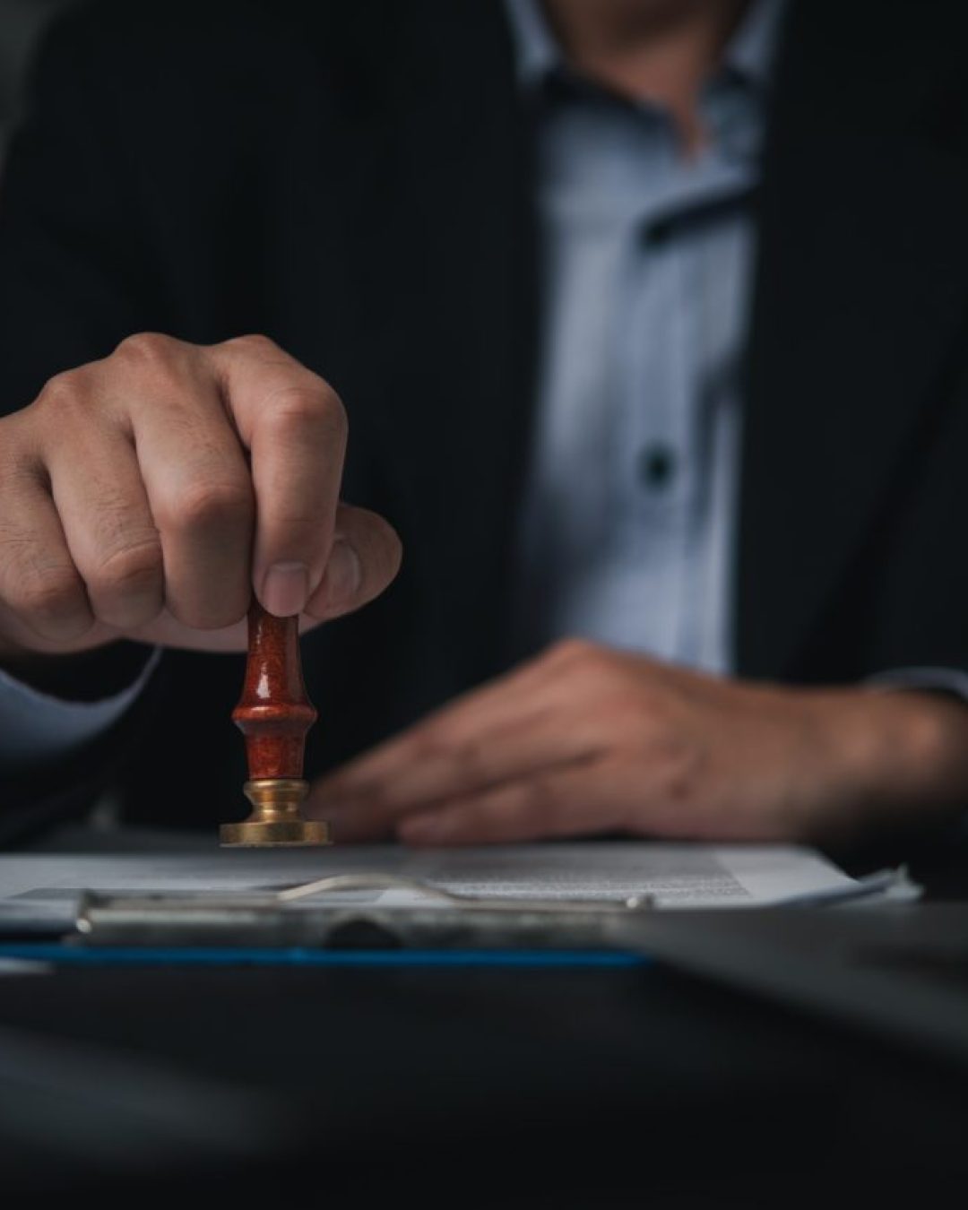 hand-man-stamping-documents-notary-public-in-office.jpg